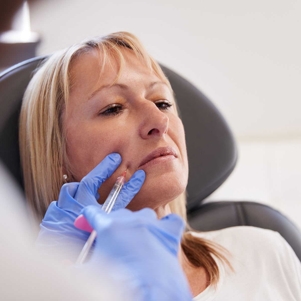 Woman getting treatment with injectable hyaluronic acid dermal filler